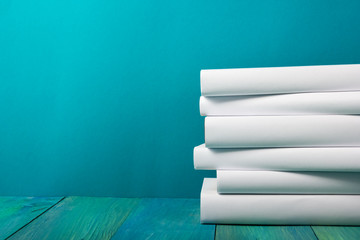 Stack of colorful books, grungy blue background, free copy space