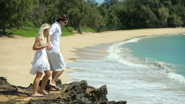 Couple on cliff overlooking beach