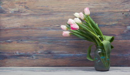 Colorful tulips flowers on wooden table. Top view with copy space. Toned picture by instagram filter