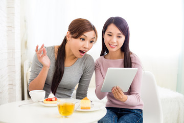 Excited woman use of tablet pc with her friends