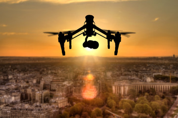 Fototapeta na wymiar Drone silhouette flying above Paris city panorama