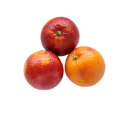 Three colorful sicilian oranges isolated on white