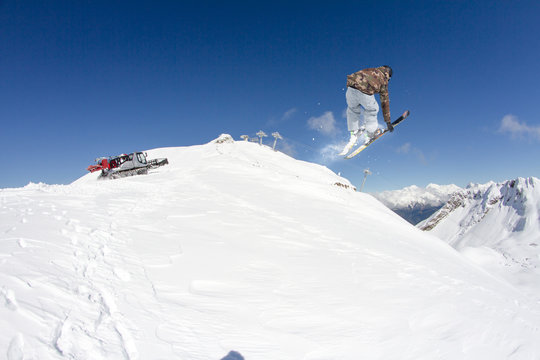 Skier on mountains, extreme jump. Winter sport.