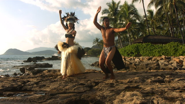 Polynesian dancers perform by ocean