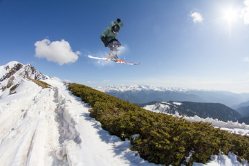 Naklejka na ściany i meble Skier on mountains, extreme jump. Winter sport.