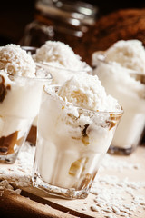 Vanilla ice cream with coconut and caramel sauce, selective focu