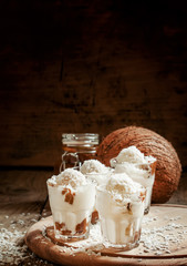 Vanilla ice cream with coconut and caramel sauce, selective focu