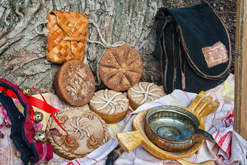 round loaf of bread, a bowl of water and other items of rural life