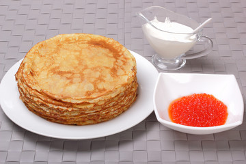 Pancakes, red caviar and sour cream