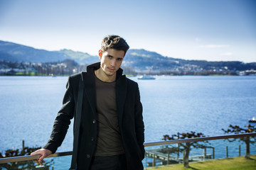 Handsome young man on Luzern lake's shore