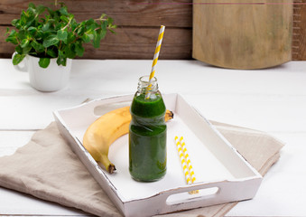 Healthy green smoothie on a wooden table
