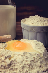 Flour with eggs and a bottle of milk.