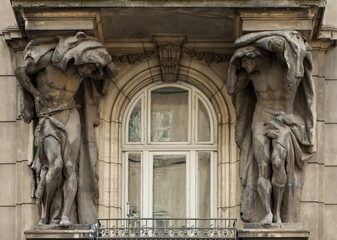 Atlanteans are supporting a balcony. Lviv, Ukraine. European travel photo.
