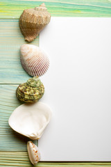 Summer sea vacation mockup background. Notebook blank page with Travel items on blue green wooden table. Sea shells, pebbles, top view.