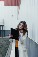 Business lady with a tablet and pen outdoors