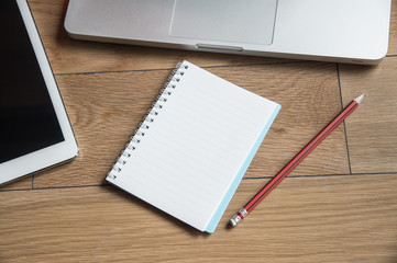 Wood office table with laptop and notebook. Top view with copy s