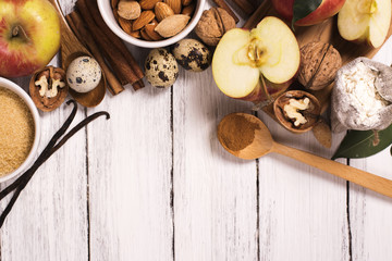 Apple pie ingrediens over white wooden background. Baking concept background