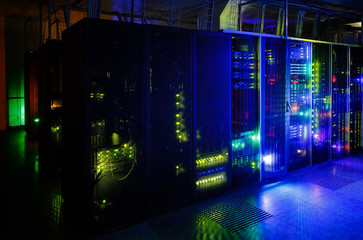 server room in the dark, with bright colored lights