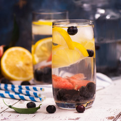 Fresh cold homemade lemonade with fruits and berries