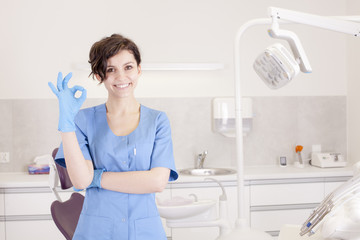 Young professional woman dentist in the dental office