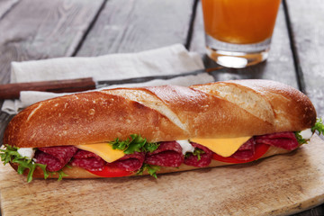 sandwich baguette cheese salami tomato sauce and herbs