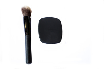 Compact closed foundation with brush and mirror isolated in white background