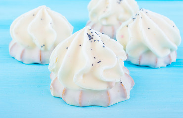 White vanilla marshmallows on a blue background. sweets for the holidays. vanilla zephyr.