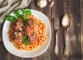 Linguine pasta with meatballs in tomato sauce and parsley