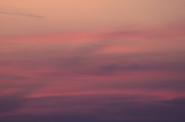 Pink blurred background of sunset cloudy sky 