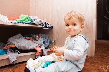 child playing with clothes