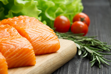 Fresh raw salmon fillet on cutting board.