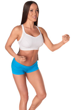 Fitness woman in sport style standing against isolated white background