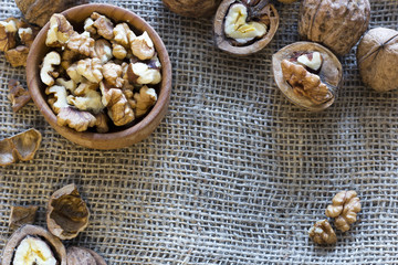 shelled walnuts in a dish and whole walnuts