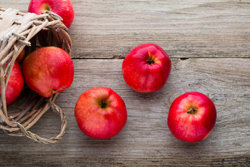 Ripe red apples on wooden background.