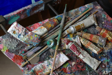 Painting palette with paint tubes and brusher
