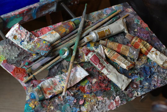 Painting palette with paint tubes and brusher
