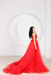 Beautiful girl in a long red dress
