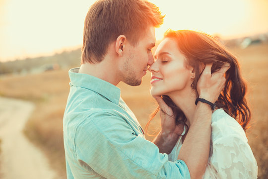 Young couple in love outdoor.Stunning sensual outdoor portrait of young stylish fashion couple posing in summer in field 