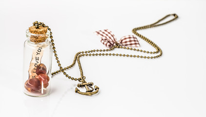 Pendant made with glass bottle, antique gold chain and amber iso