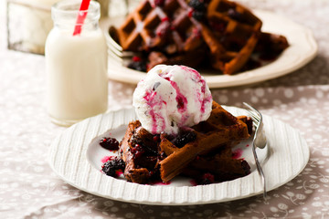  chocolate waffle with ice cream and berry sauce