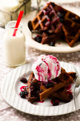  chocolate waffle with ice cream and berry sauce