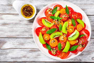 tomatoes, kiwi fruit, mint salad dressed with shredded cheese br