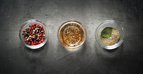 Three glass bowls with herbs and spices