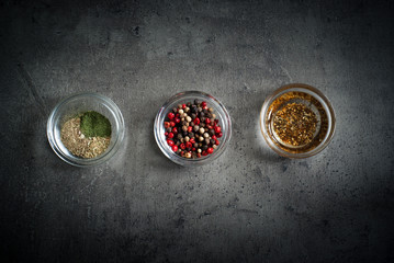 Three glass bowls with herbs and spices
