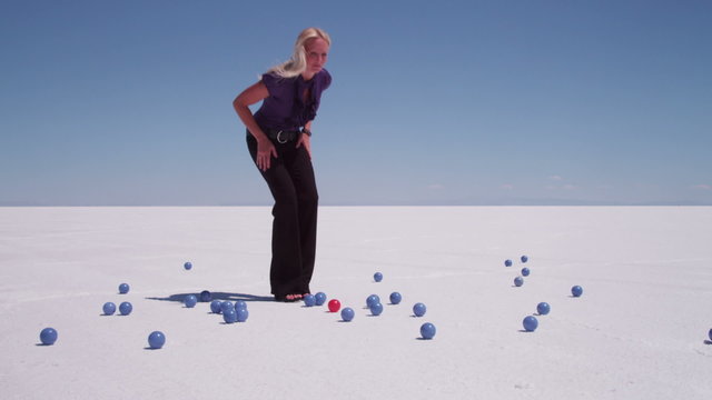 Businesswoman finds red ball amongst many blue ones