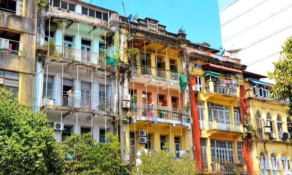 Yangon, Myanmar - March 9, 2015: A street archtecture view with colonial building in the town of Yangon