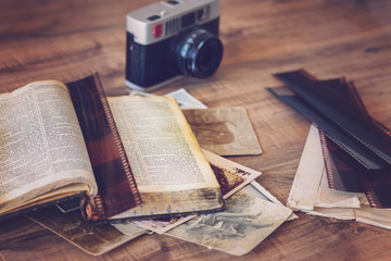 Photo of old book and camera with old photos and film strips
