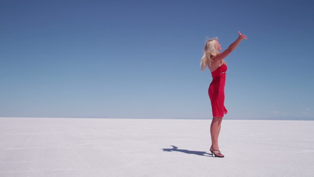 Woman in red dress spinning, slow motion