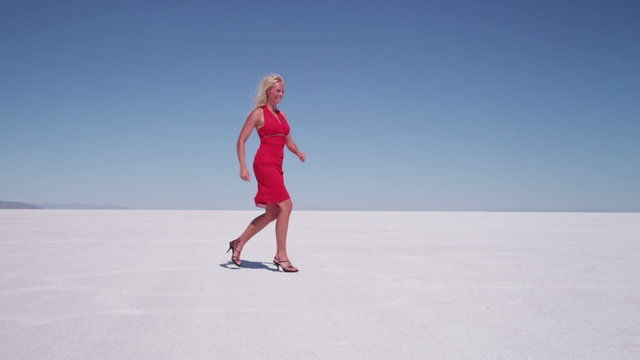 Woman in red dress running and jumping, slow motion