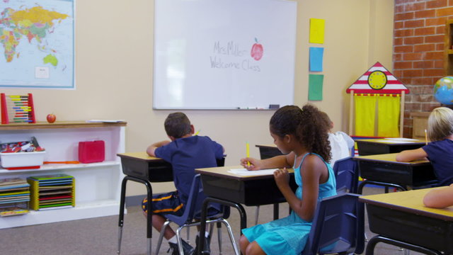 Elementary school students work at desks